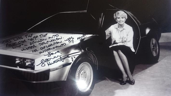 Framed, autographed photo of TV star Gloria Hunniford in DMC-12 car