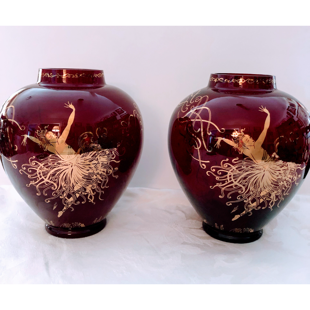 A beautiful pair of vases red glass with gold etching of ladies dancing. Signed Applause 1990