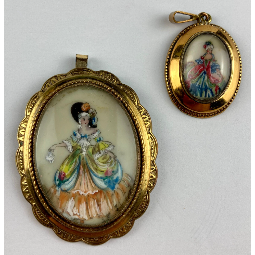 Two costume jewelry pendants of painted ladies. Timeless. ( 4½ cm and 2½ cm)