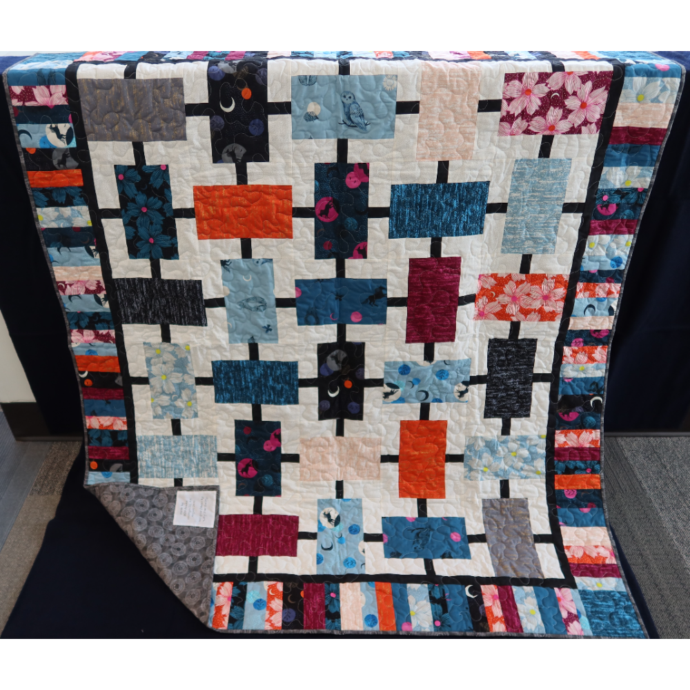 Handmade Quilt In Blue, Orange, And Pink