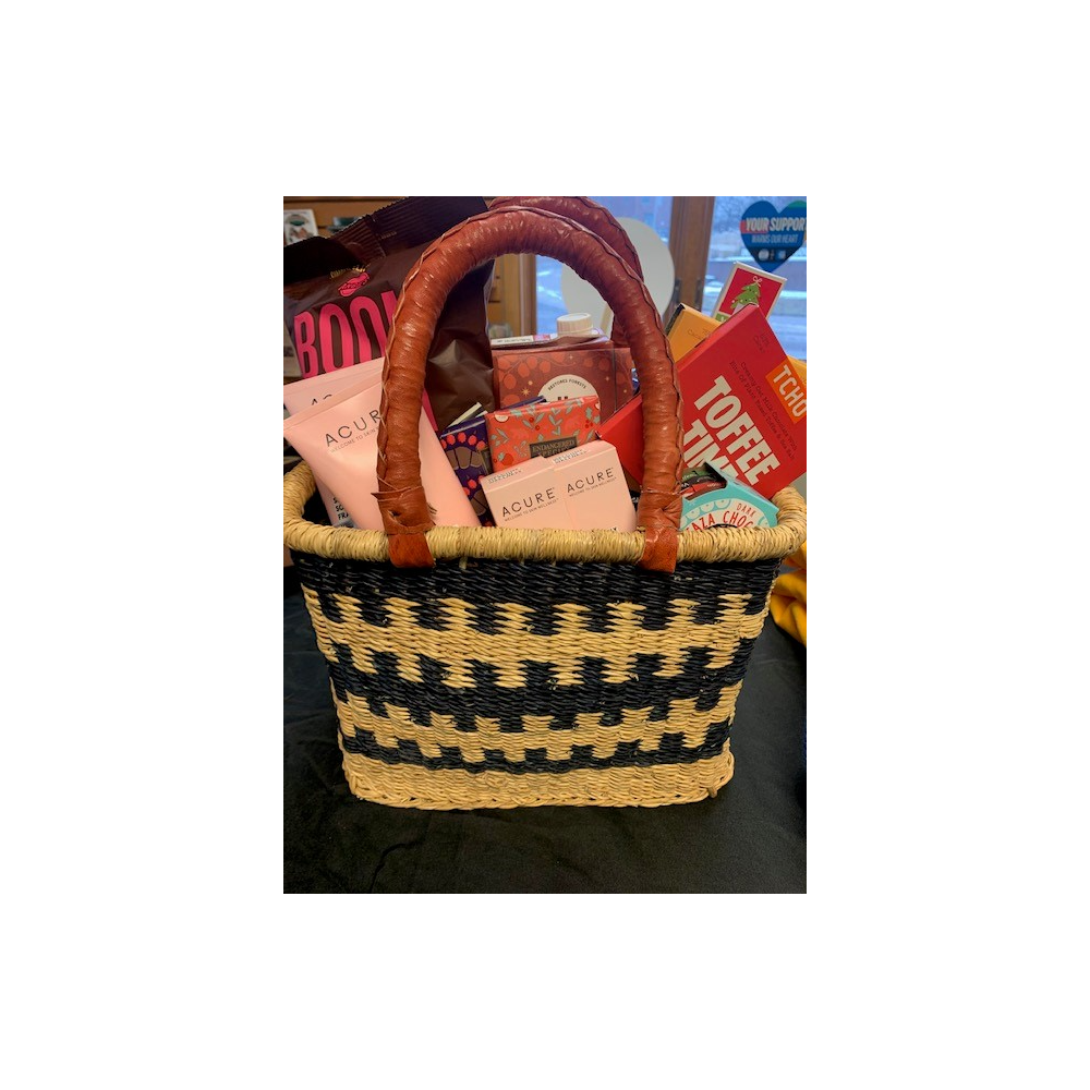 Handmade African Basket containing self-care and multiple chocolate items 