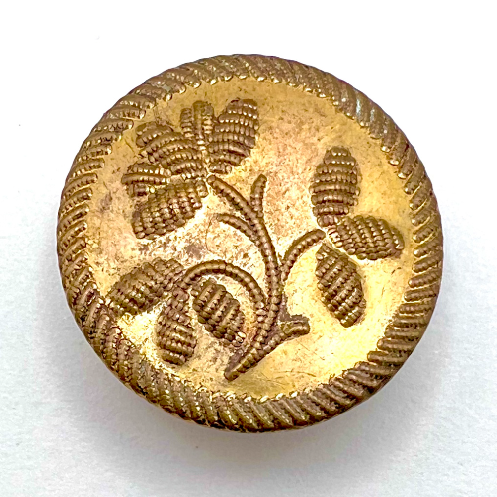 An 18th c. Repoussé button with plant life button.
