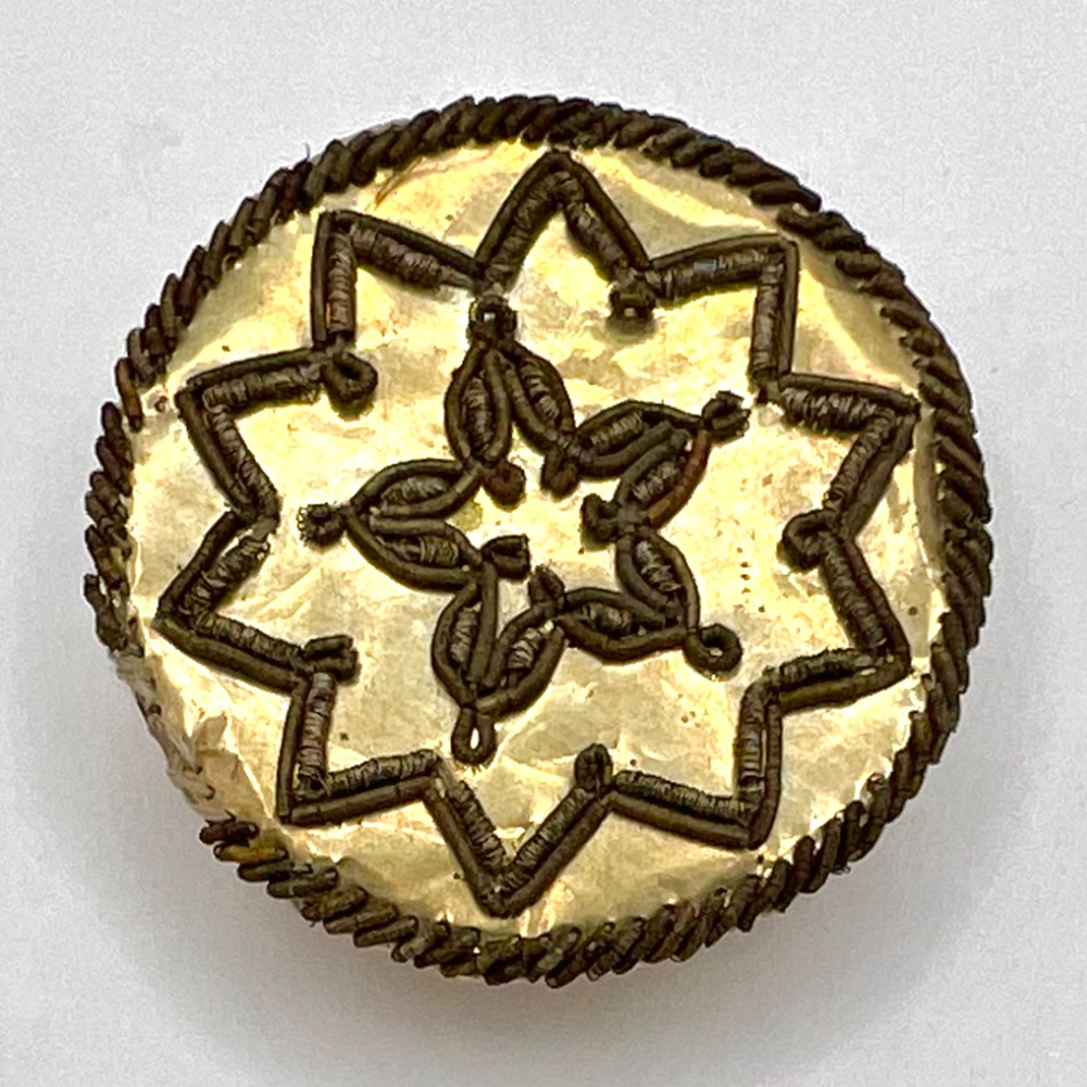 An 18th c. French Passementrie floral in a 10 pointed star  button.