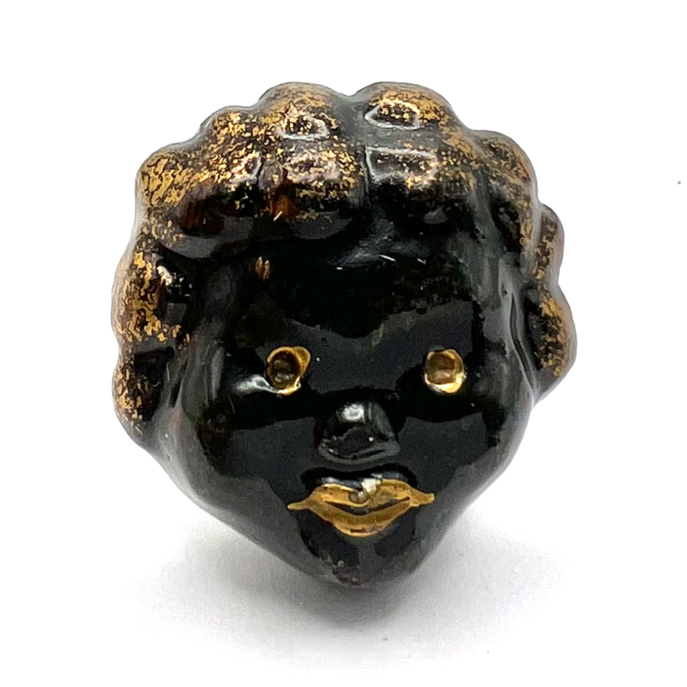 Ceramic African American child face button.