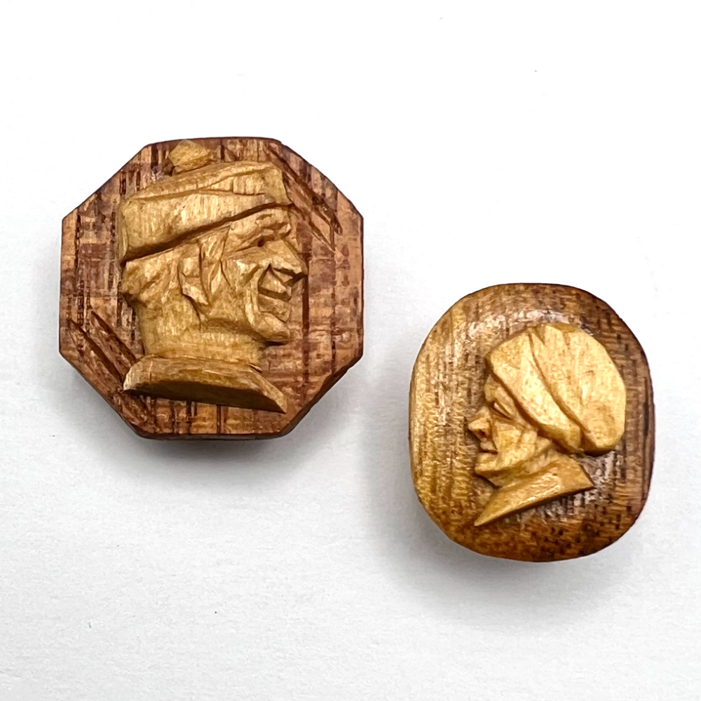 Two carved wood buttons by Andri Bourgault.